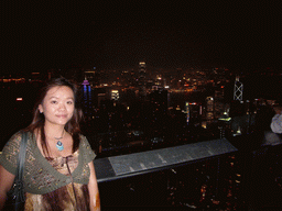 Miaomiao at Victoria Peak, with a view on the skyline of Hong Kong and Kowloon with the Two International Finance Centre and the Bank of China Tower, and Victoria Harbour, by night