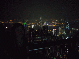 Miaomiao at Victoria Peak, with a view on the skyline of Hong Kong and Kowloon with the Two International Finance Centre and the Bank of China Tower, and Victoria Harbour, by night