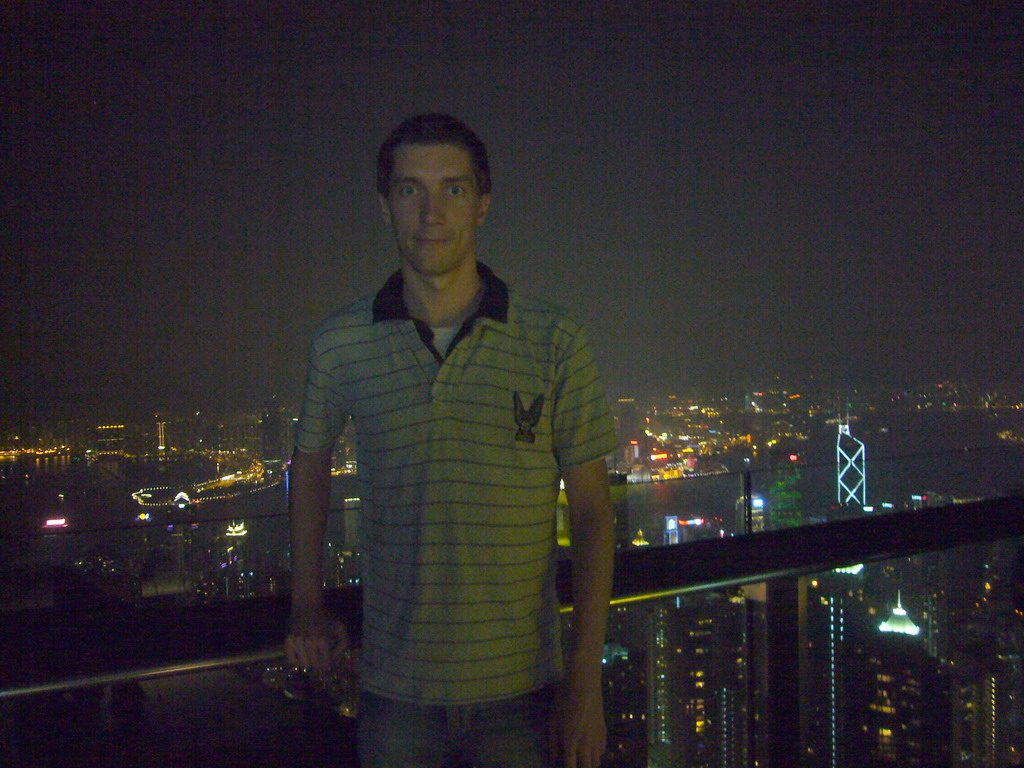 Tim at Victoria Peak, with a view on the skyline of Hong Kong and Kowloon with the Bank of China Tower, and Victoria Harbour, by night