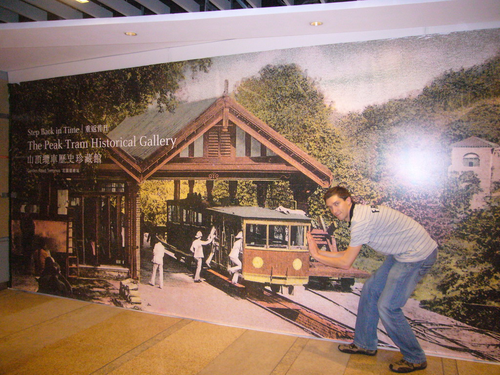 Tim with a poster of the Peak Tram Historical Gallery, at Victoria Peak