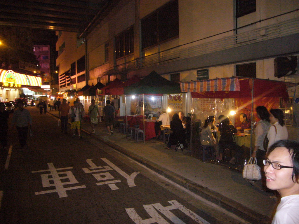 Market stalls in a street at Kowloon, by night