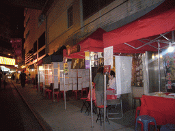 Market stalls in a street at Kowloon, by night