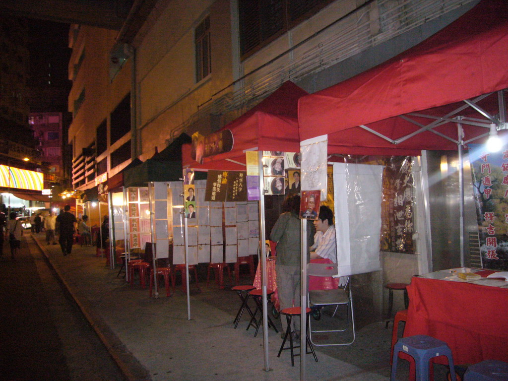 Market stalls in a street at Kowloon, by night