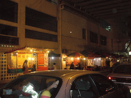 Market stalls in a street at Kowloon, by night