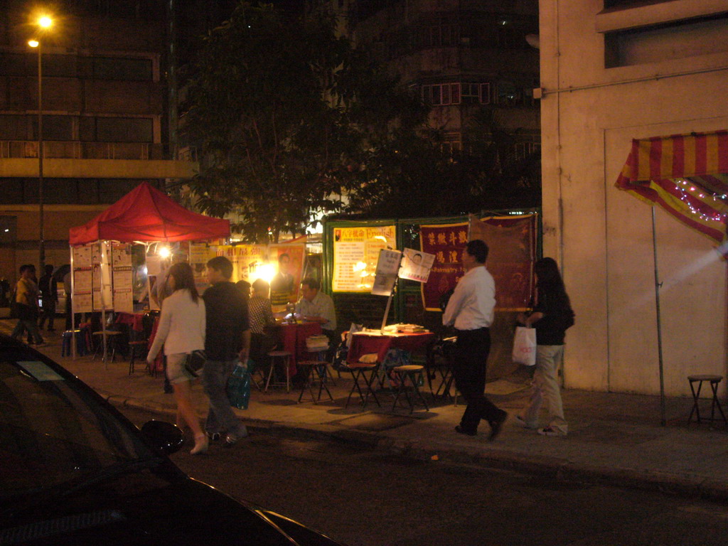 Market stalls in a street at Kowloon, by night