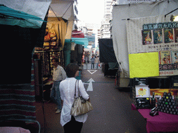 Miaomiao in a street with market stalls at Kowloon