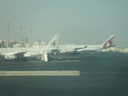 Airplanes and buildings close to Doha International Airport, viewed from the Departure Hall
