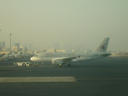 Qatar Airways airplane and the skyline of Doha, viewed from the Departure Hall of Doha International Airport