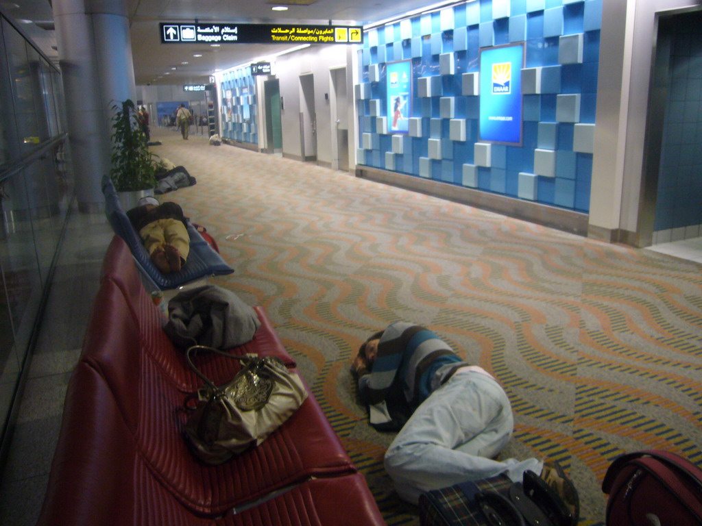 Tim sleeping on the floor of the Transit Hall of Dubai International Airport