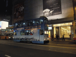 Tram in front of the Nan Fung Tower at the Des Voeux Road, by night