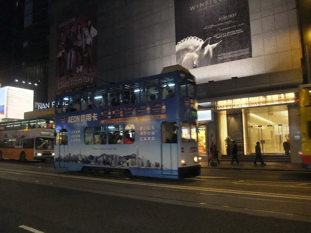 Tram in front of the Nan Fung Tower at the Des Voeux Road, by night