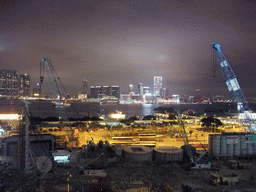 Victoria Harbour with Central Ferry Pier 6, 7 (Star Ferry Pier) and 8, and the skyline of Kowloon, viewed from the roof terrace of the IFC Mall, by night