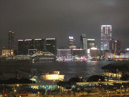 Victoria Harbour with Central Ferry Pier 7 and 8, and the skyline of Kowloon, viewed from the roof terrace of the IFC Mall, by night