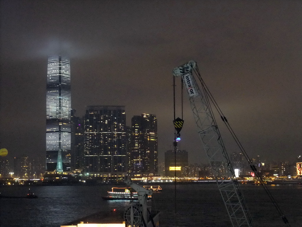 Victoria Harbour and the skyline of Kowloon with the International Commerce Centre, viewed from the roof terrace of the IFC Mall, by night