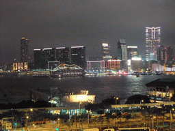 Victoria Harbour with Central Ferry Pier 6 and 7, and the skyline of Kowloon, viewed from the roof terrace of the IFC Mall, by night