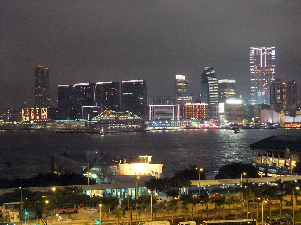 Victoria Harbour with Central Ferry Pier 6 and 7, and the skyline of Kowloon, viewed from the roof terrace of the IFC Mall, by night