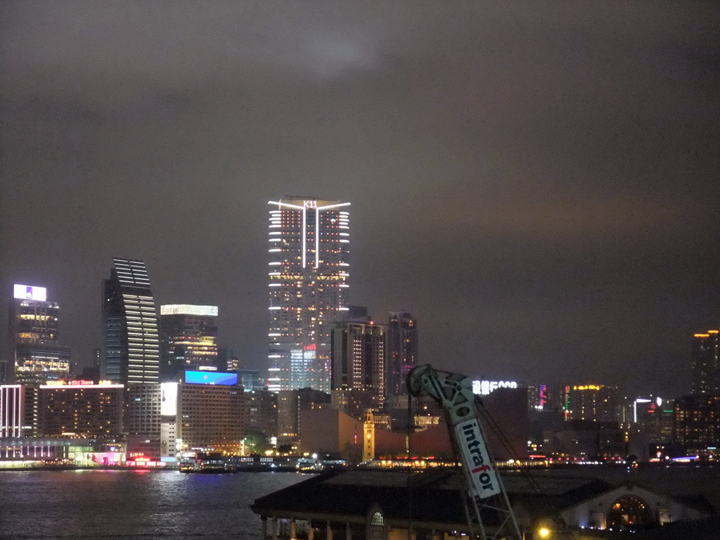 Victoria Harbour with the Star Ferry Pier and the skyline of Kowloon, viewed from the roof terrace of the IFC Mall, by night