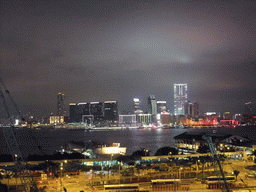 Victoria Harbour with Central Ferry Pier 6 and 7, and the skyline of Kowloon, viewed from the roof terrace of the IFC Mall, by night