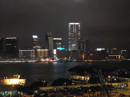Victoria Harbour with the Star Ferry Pier and the skyline of Kowloon, viewed from the roof terrace of the IFC Mall, by night