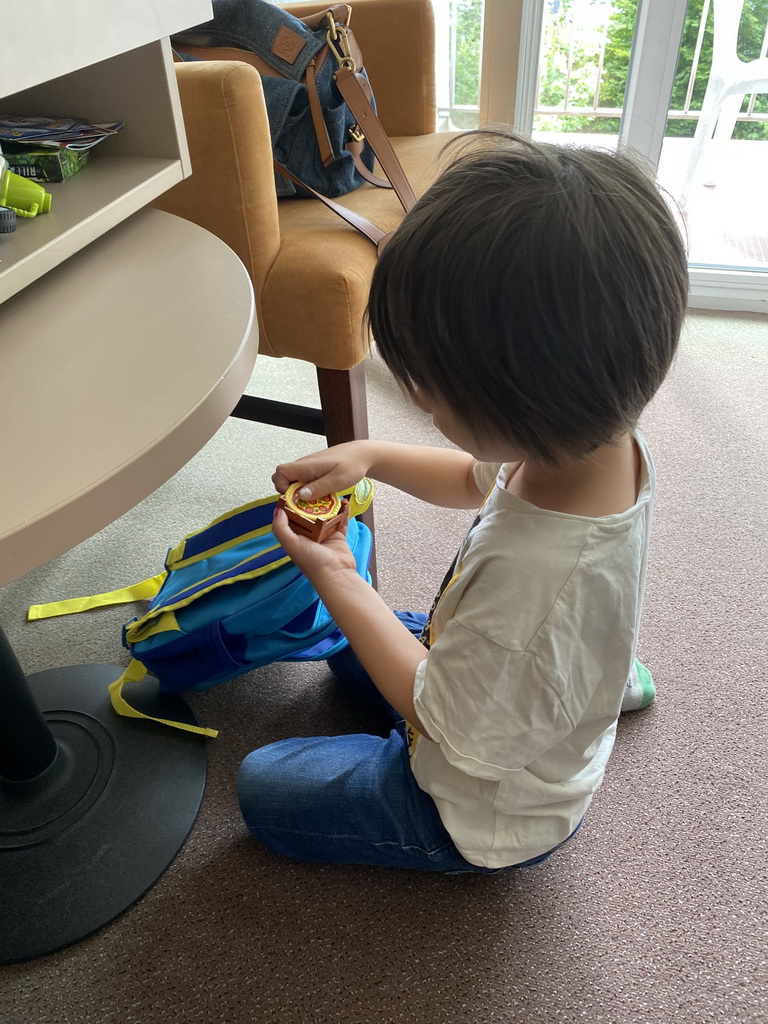 Max playing with toys in our room at the Vayamundo Houffalize hotel