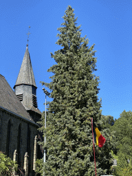 Tree and Belgian flag for the Belgian National Day next to the Église Sainte-Catherine church at the Cour de l`Abbaye court