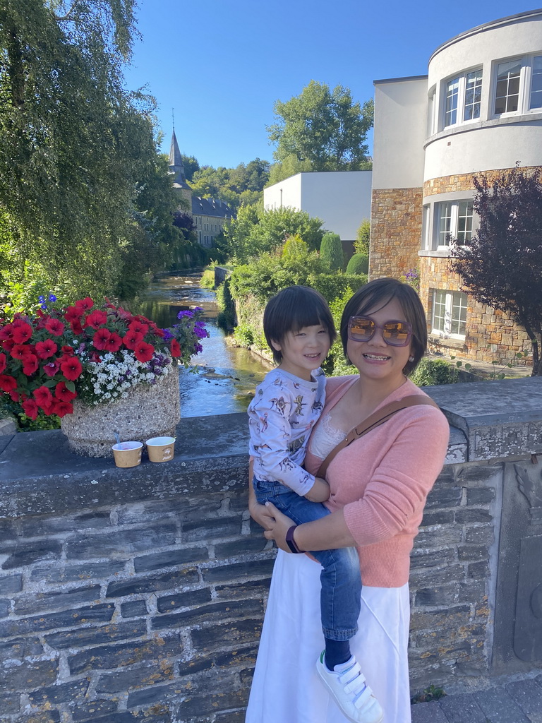 Miaomiao and Max at the bridge at the Rue de Liège street, with a view on the north side of the Eastern Ourthe river and the Église Sainte-Catherine church