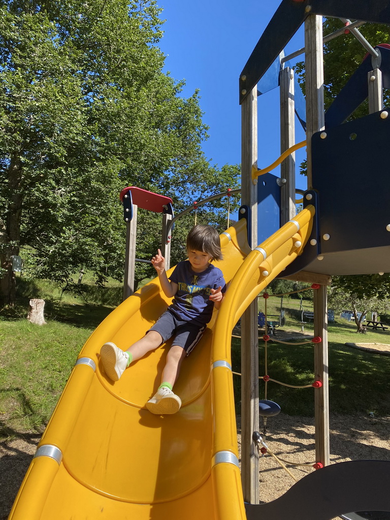 Max on a slide at the playground at the petting zoo near the Vayamundo Houffalize hotel