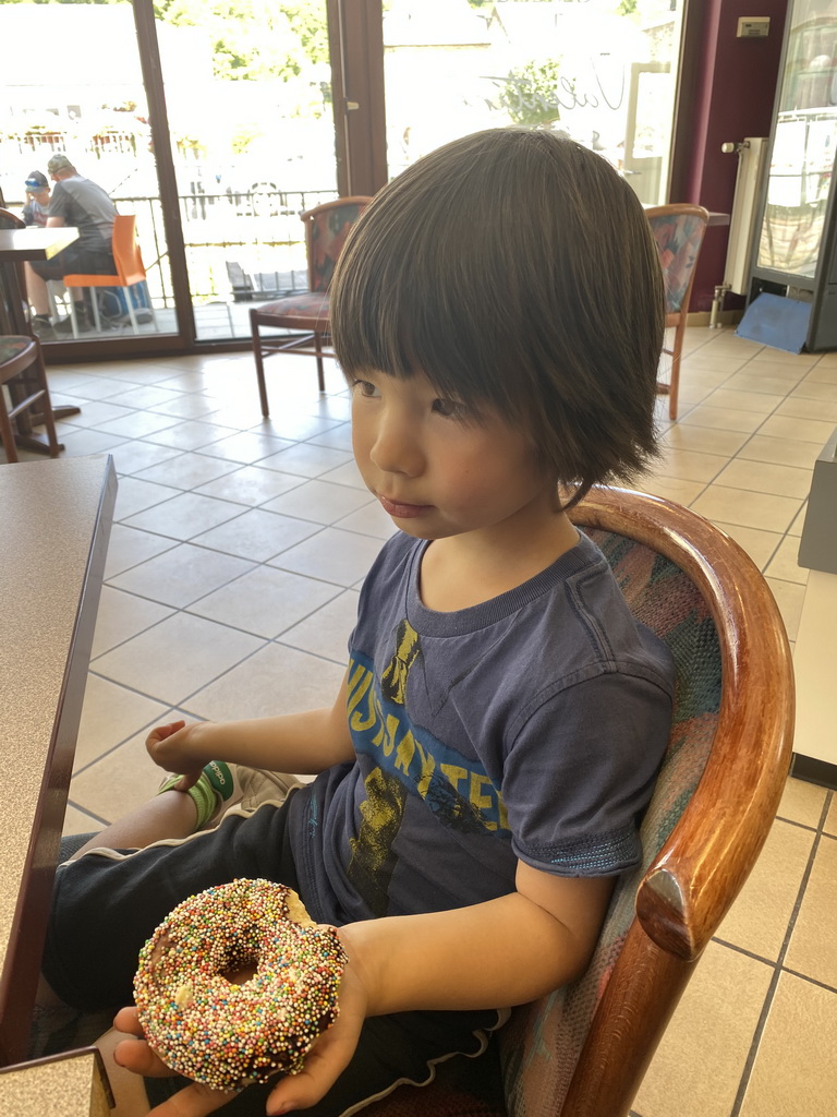 Max eating a donut at the Valentine Boulangerie-Pâtisserie restaurant