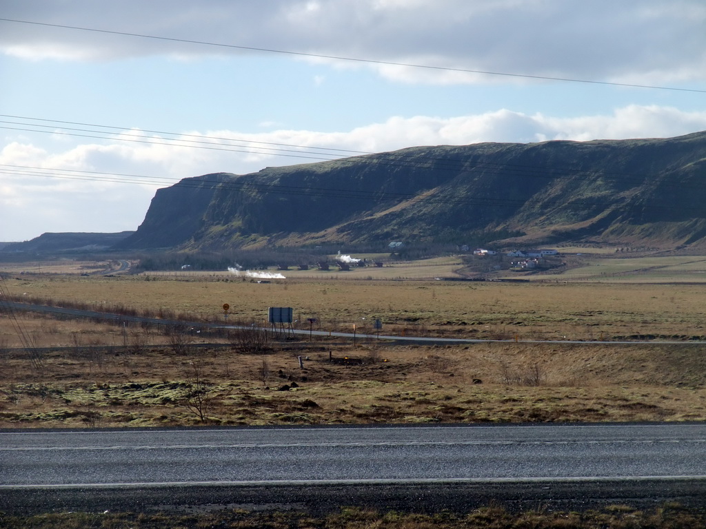 The Suðurlandsvegur road and mountains and geysers west of Hveragerthi, viewed from a parking place in Hveragerthi