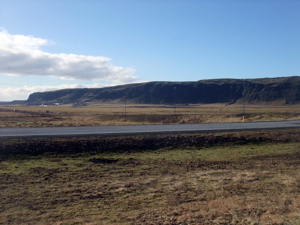 The Suðurlandsvegur road and mountains and geysers west of Hveragerthi, viewed from a parking place in Hveragerthi