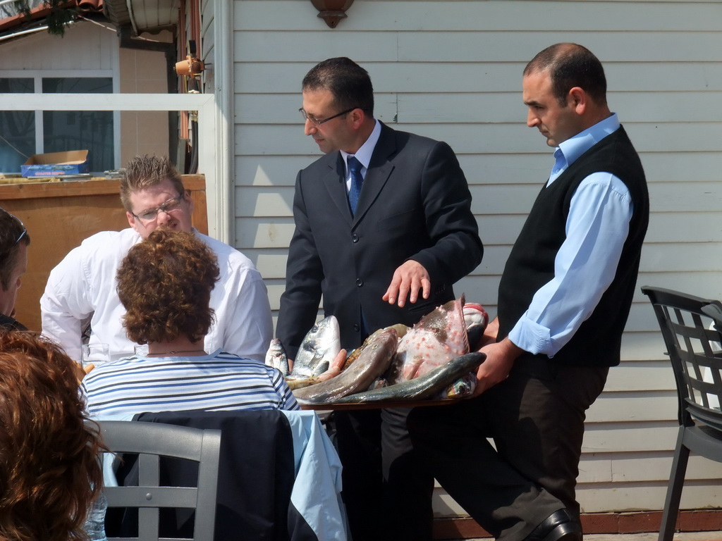 Waiters with fish plate at Beyaz Restaurant