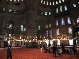 Praying muslims and interior of the Blue Mosque