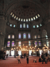 Praying muslims and interior of the Blue Mosque