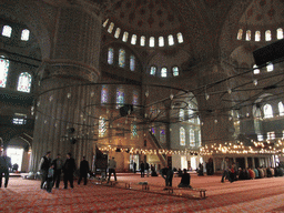 Praying muslims and interior of the Blue Mosque