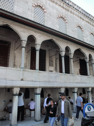 Muslims washing themselves at the ablutions fountains at the side of the Blue Mosque