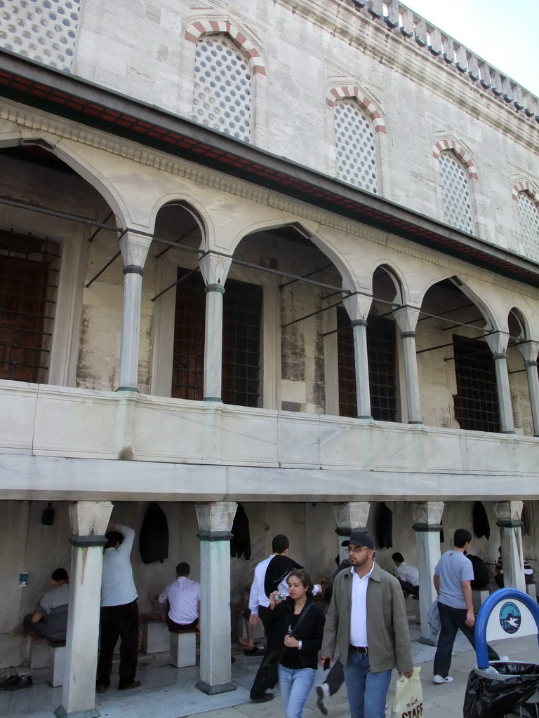 Muslims washing themselves at the ablutions fountains at the side of the Blue Mosque