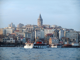 The Beyoglu district with the Galata Tower and a boat in the Golden Horn bay