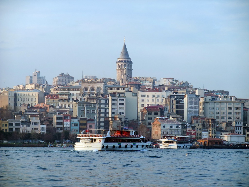 The Beyoglu district with the Galata Tower and a boat in the Golden Horn bay