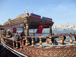 Fish boat restaurant in the Golden Horn bay, and the Galata Tower in the Beyoglu district