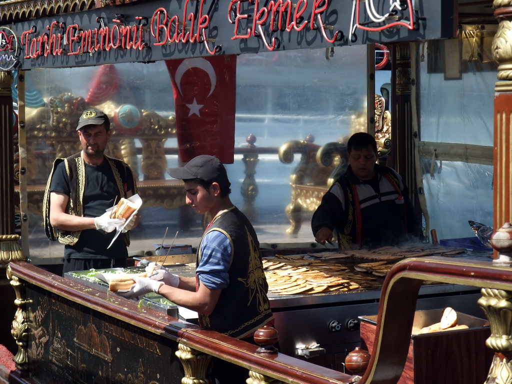 Cooks preparing fish at a fish boat restaurant in the Golden Horn bay