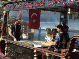 Cooks preparing fish at a fish boat restaurant in the Golden Horn bay