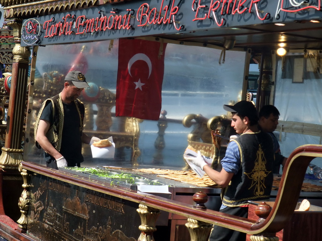 Cooks preparing fish at a fish boat restaurant in the Golden Horn bay