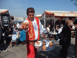 Snack salesman in front of the fish boat restaurants in the Golden Horn bay