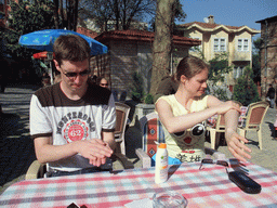 Tim and Nardy putting on sunscreen, on the square in front of the Church of St. Savior in Chora