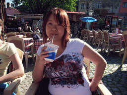 Miaomiao drinking ayran on the square in front of the Church of St. Savior in Chora