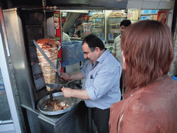 Miaomiao and the cook cutting doner kebab in a snackbar at Divan Yolu Caddesi street