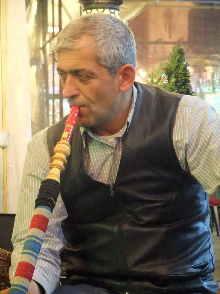 Man smoking waterpipe in the Corlulu Ali Pasa Medresesi medrese