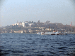 Topkapi Palace and a boat in the Bosphorus strait, viewed from the ferry to the Princes` Islands (Prens Adalari)