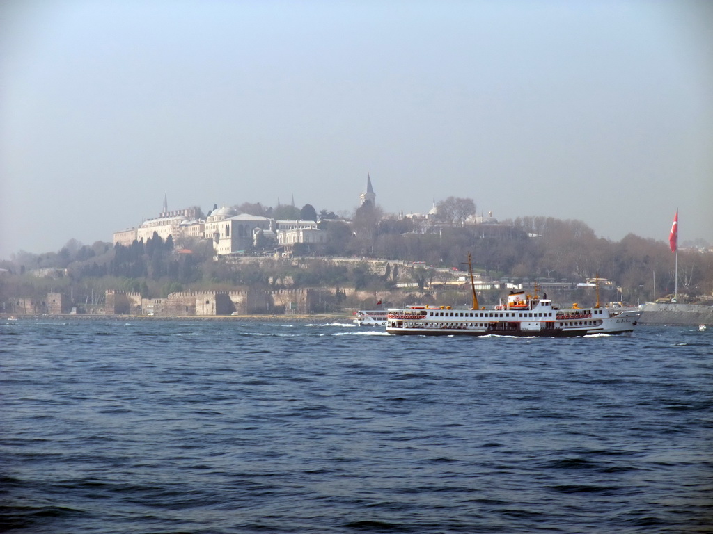 Topkapi Palace and a boat in the Bosphorus strait, viewed from the ferry to the Princes` Islands (Prens Adalari)