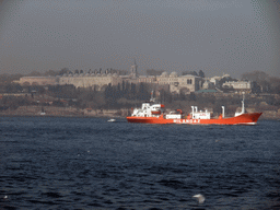 Topkapi Palace and a boat in the Bosphorus strait, viewed from the ferry